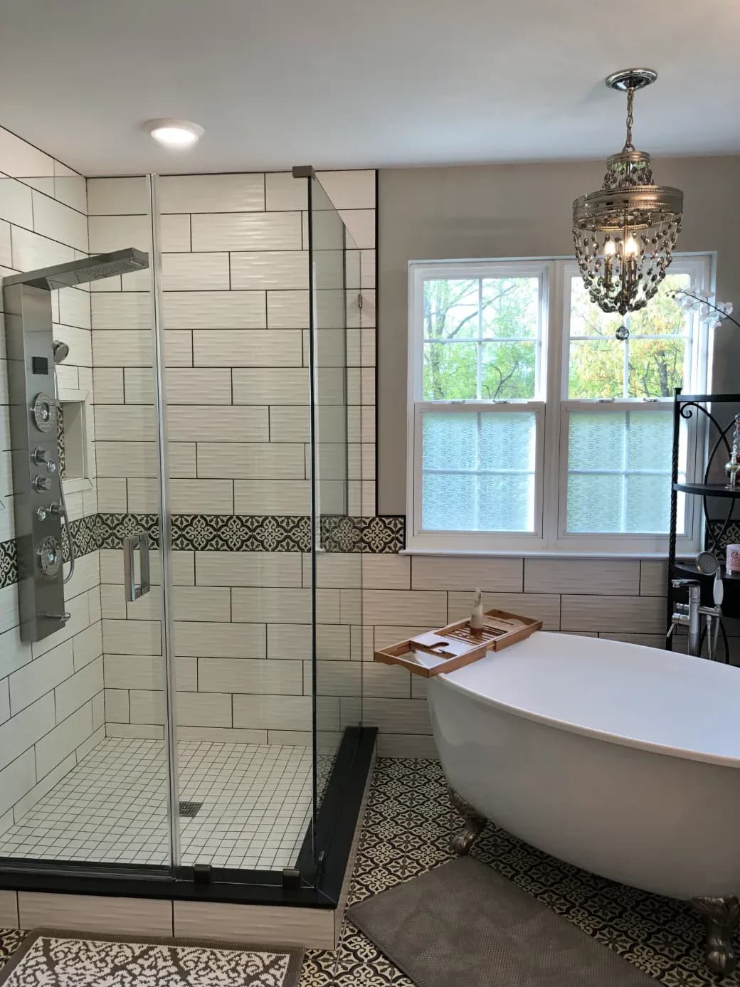 A white soaking bathtub and walk-in glass tiled shower.