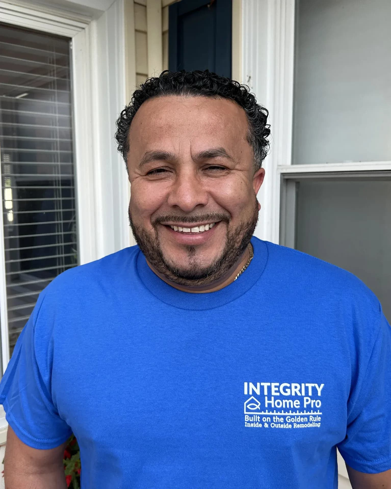 A headshot of a team member in a blue Integrity Home Pro t-shirt.