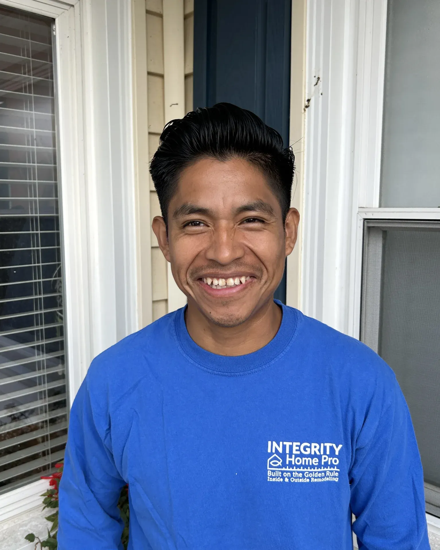 A headshot of a team member in a blue Integrity Home Pro t-shirt.