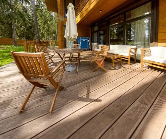 A wooden deck installation with a table and chairs.